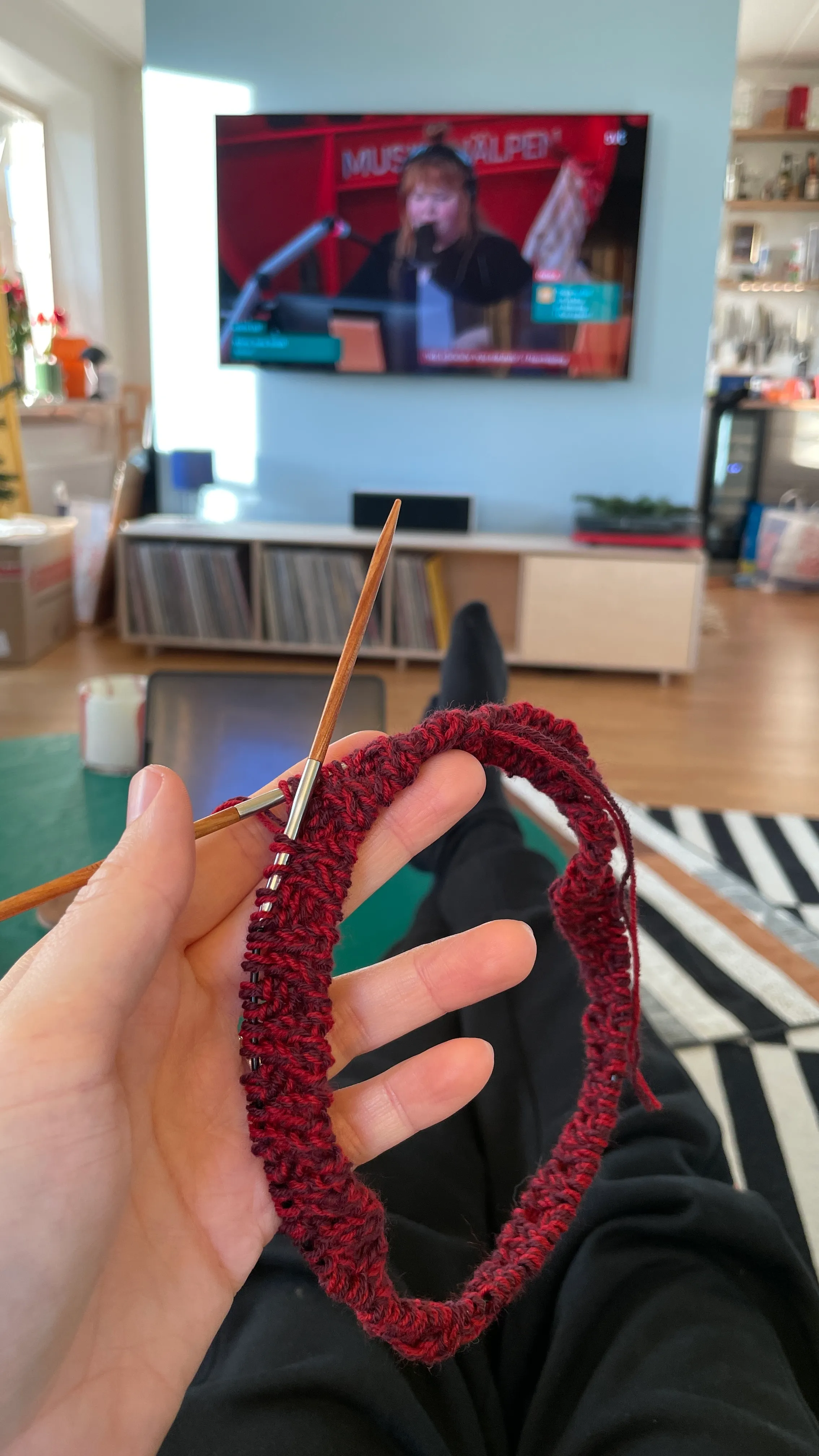 Malin holding a red knitted item