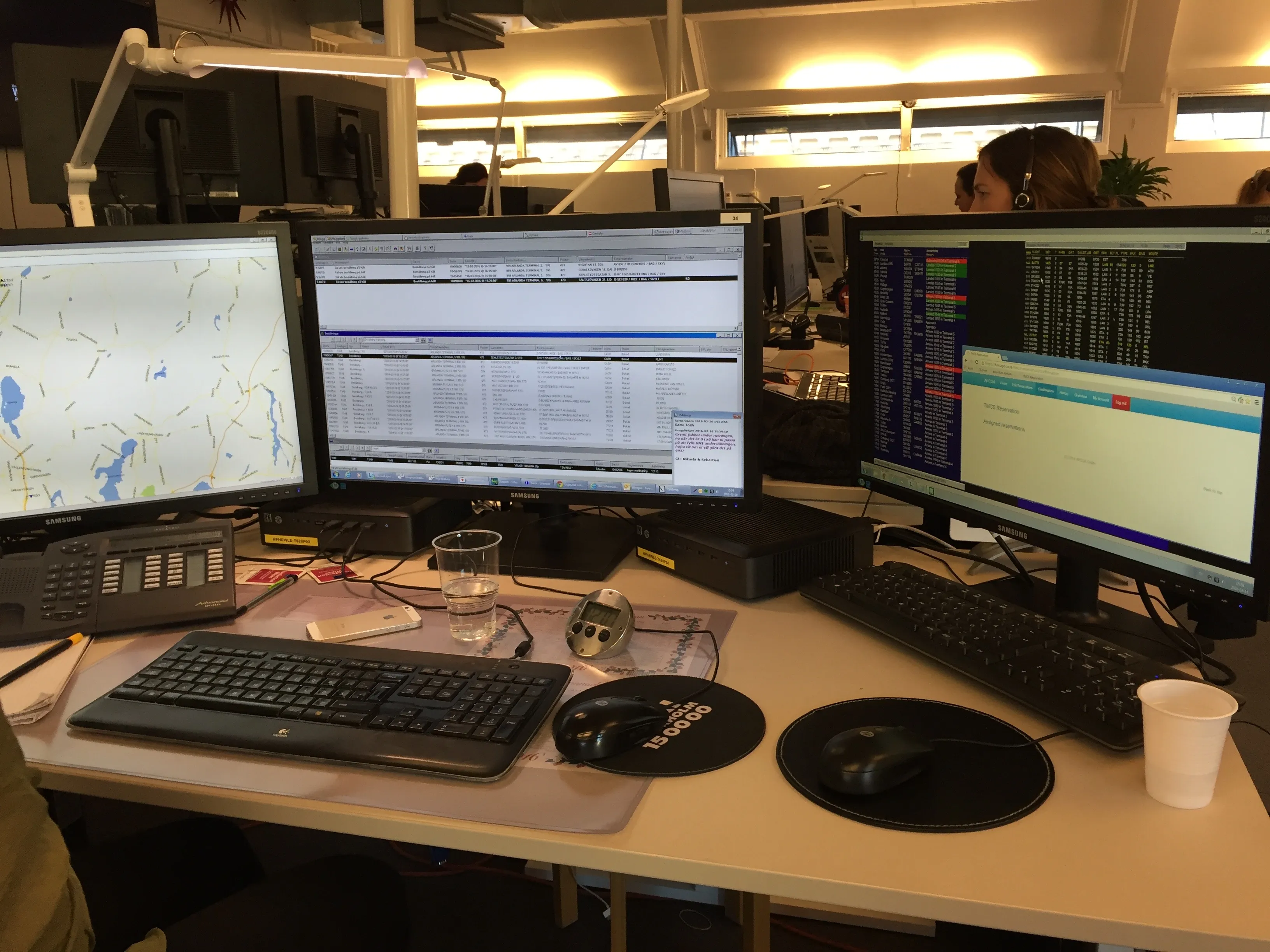The airport booking team at their desks with several screens each